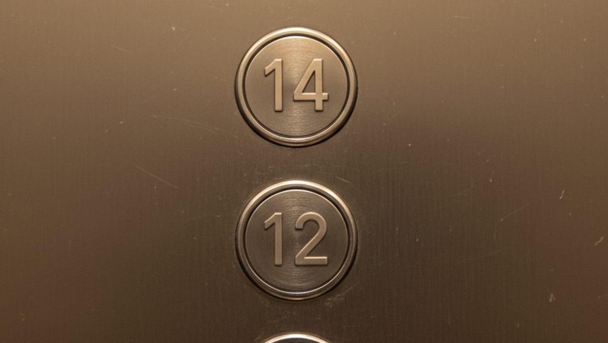 An elevator button panel where the floor numbers run 12, then 14.